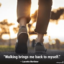 close up image of a persons shoes while walking outside with text quote "Walking brings me back to myself" by Laurette Mortimer